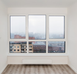 Apartment window in a multi-storey house white room