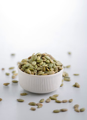 Dry pumpkin seeds in a small cup