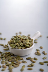 Dry pumpkin seeds in a small cup