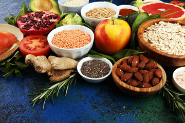 Healthy food clean eating selection: fish, fruit, vegetable, cereal, leaf vegetable on rustic background