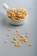 Dry watermelon seeds in a white cup