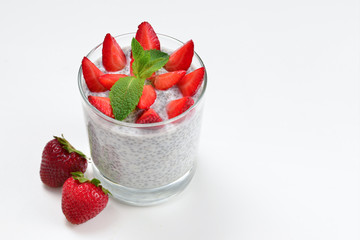 Chia pudding with strawberry and mint on a white background. Space for text or design.