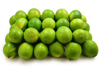 Many fresh limes on white background.