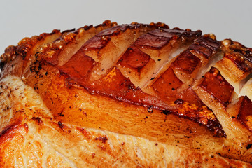 Close-up of roast pork with crackling against white background