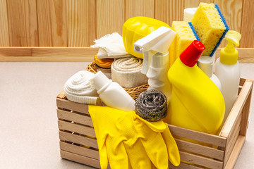 House cleaning product in wooden box. Spray, bottle, gloves, dishwashing sponge, scraper, gel air...