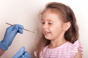 Dental medicine and healthcare - dentist examining little child girl patient open mouth showing...