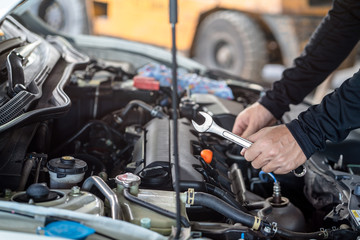 Fototapeta na wymiar Hand of mechanic man hold spanner tool, inspection and maintenance car service