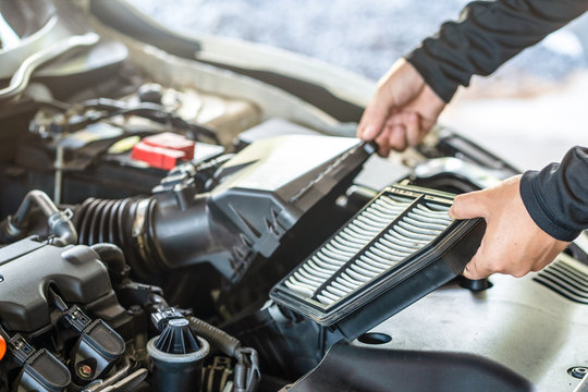 Hand of mechanic man remove air filter of the engine, inspection and  maintenance car service
