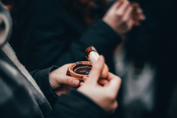 Woman hands eating liquid chocolate on the Chocolate market chocolART in Tübingen, Germany with...