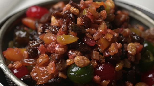 A bowl of dry mix fruit after soaked in rum for making fruit cake.