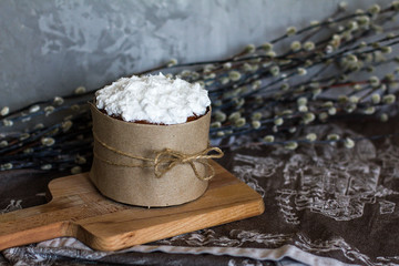One cake on a dark background. Cake with white icing. Birthday cake. palm Sunday. Pie and willow branches. Wonderful decoration. Homemade delicious and beautiful pastries. bow of rope.