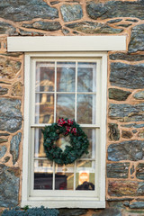 Fototapeta na wymiar Christmas Wreath, Mistletoe decoration on vintage glass window and wall stone