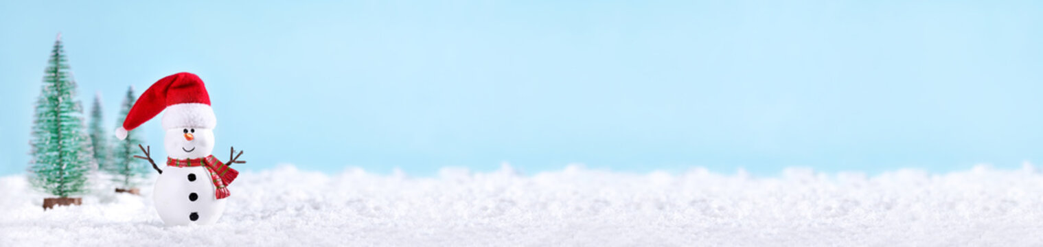 Christmas greeting card. Snowman and new year trees on snow over blue paper background