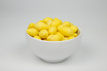 Ginkgo nuts in white bowl on white background