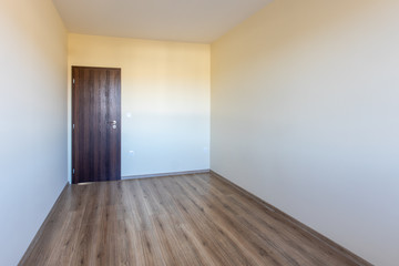 Empty bright room. New home interior. Wooden floor.