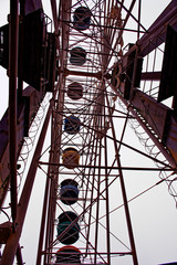 old empty carousel ferris wheel overcast autumn day