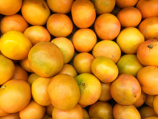 Oranges fruits with green leaves closeup. Mobile photo