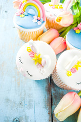 Easter holiday greeting card background. Cute homemade cupcakes with traditional Easter bunny, egg...