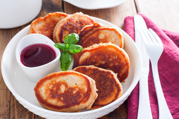 Buckwheat pancakes on a white plate in jam, selective focus