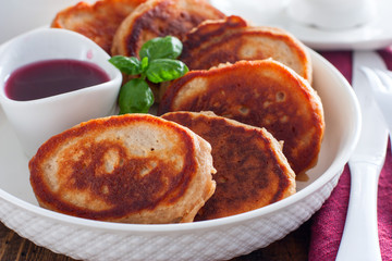 Buckwheat pancakes on a white plate in jam, selective focus