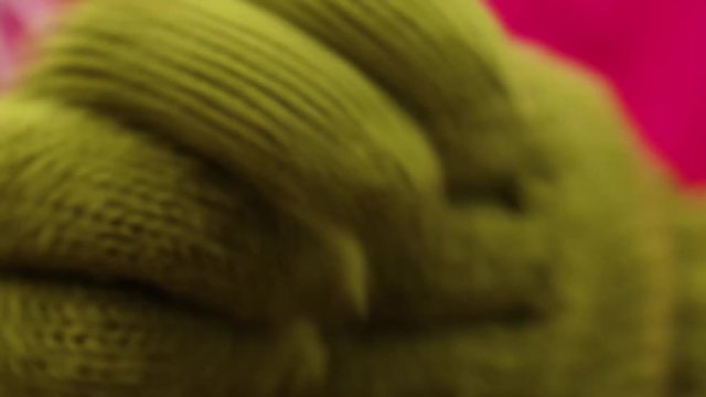 two female hands rub against each other on the street in winter