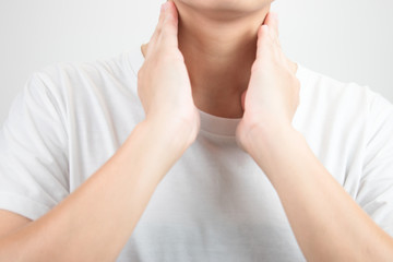 Asian people have a sore throat. By using two hands to touch the neck