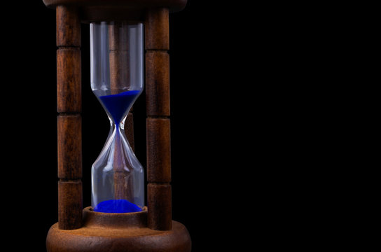Hourglass isolated on black background with copyspace