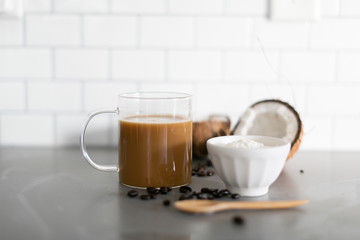 Cup of coffee with keto coconut creamer in white modern kitchen 