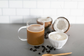 Cup of coffee with keto coconut creamer in white modern kitchen 
