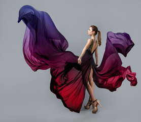 beautiful young girl in flying dress. Flowing fabric in the shape of butterfly wings.