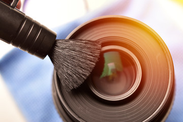 cleaning camera lens with brush, lens cleaning