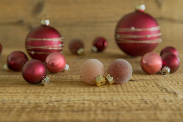Christmas tree balls placed on a wooden board for decoration.
