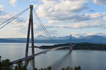 Fototapeta na wymiar Suspension bridge connecting Islands with mountains in background in narvik, Norway