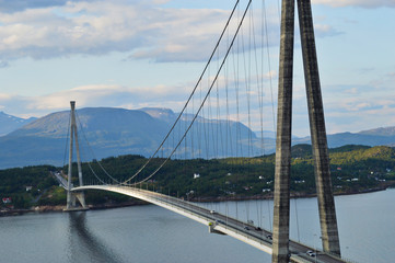 Suspension bridge connecting Islands with mountains in background in narvik, Norway