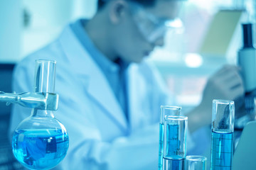 concept of medical, chemicals or scientific laboratory research and Innovation in the laboratory. experienced handsome Asian man scientist is performing work in the laboratory.