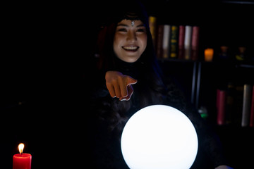 Blur image of Beautiful young Asian woman Gypsy Fortune teller glowing crystal ball, tarot cards...