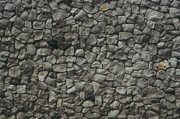 Wall of textured stones in dark colors