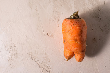 ugly vegetables, carrots on a light background.funny monster carrot The concept of non-waste...