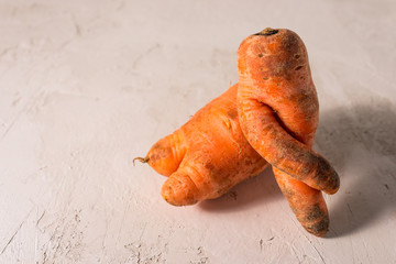 ugly vegetables, carrots on a light background.funny monster carrot The concept of non-waste...
