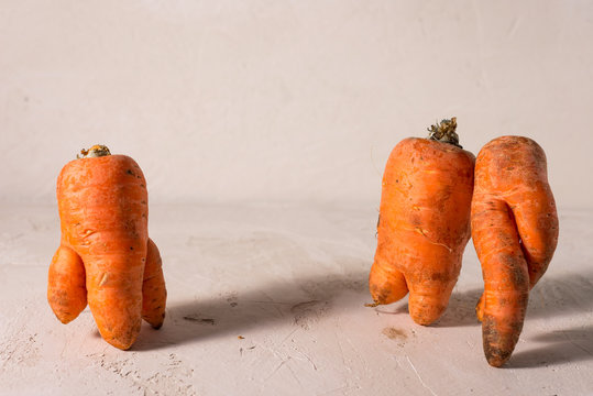 ugly vegetables, carrots on a light background.funny monster carrot The concept of non-waste production in the food industry