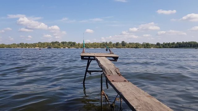 old panton on the river. sunny day and calm water. the opposite shore with greenery is visible on the horizon