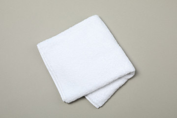 White towel isolated on grey background, top view and space for text