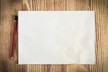 Sheet of paper lying on wooden table