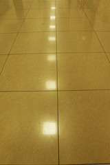 Background, ceramic tiles, flooring, reflection of lamps on the tile.