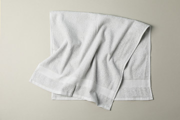 Fresh grey towel on grey background, top view