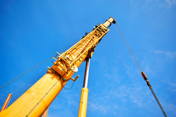 Fototapeta na wymiar Mobile cranes working lifting equipment on construction site,Hydraulic cylinder,Boom crane.December 2019
