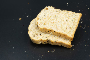Fresh wheat bread slice isolated on black background.