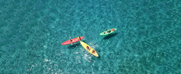 Aerial drone top view photo of friends practising canoe in tropical exotic turquoise sandy beach