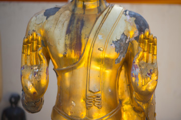 Closed up hand of Gold Buddha in Wat Phra That Bang Phuan in Nongkhai of Thailand