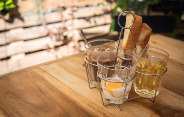 Breakfast set with soft boiled egg, coffee, crispy baked bread and tea. Thai style and vintage cuisine.